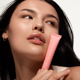 Summer Fridays applied on lips showing sheer pink color and luminous shine