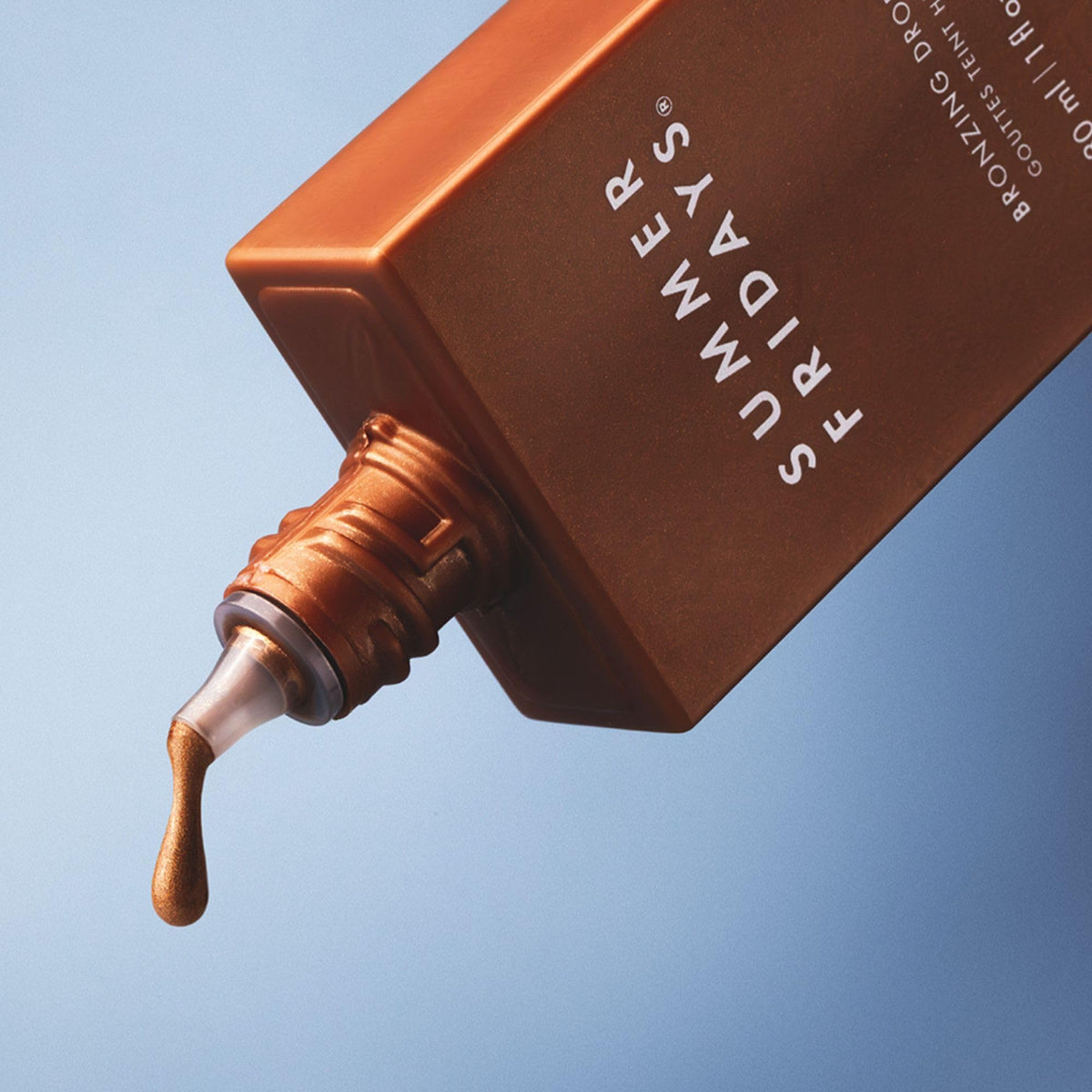 Summer Fridays bronzing drops texture close-up on skin, revealing dewy finish benefit