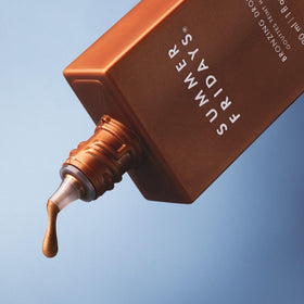 Summer Fridays bronzing drops texture close-up on skin, revealing dewy finish benefit
