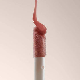 Summer Fridays lip oil flatlay with skincare, boosts shine and layers well