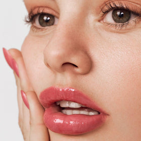 Summer Fridays pink guava swatch on skin demonstrating sheer tint and shine