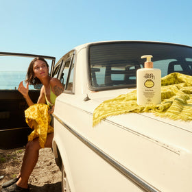 Sun Bum 8 oz bottle in hand showing portable travel-friendly size