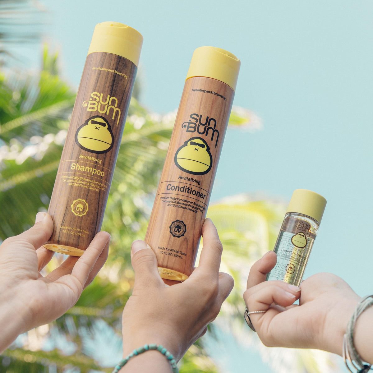 Sun Bum applying oil to hair ends reducing frizz and improving manageability