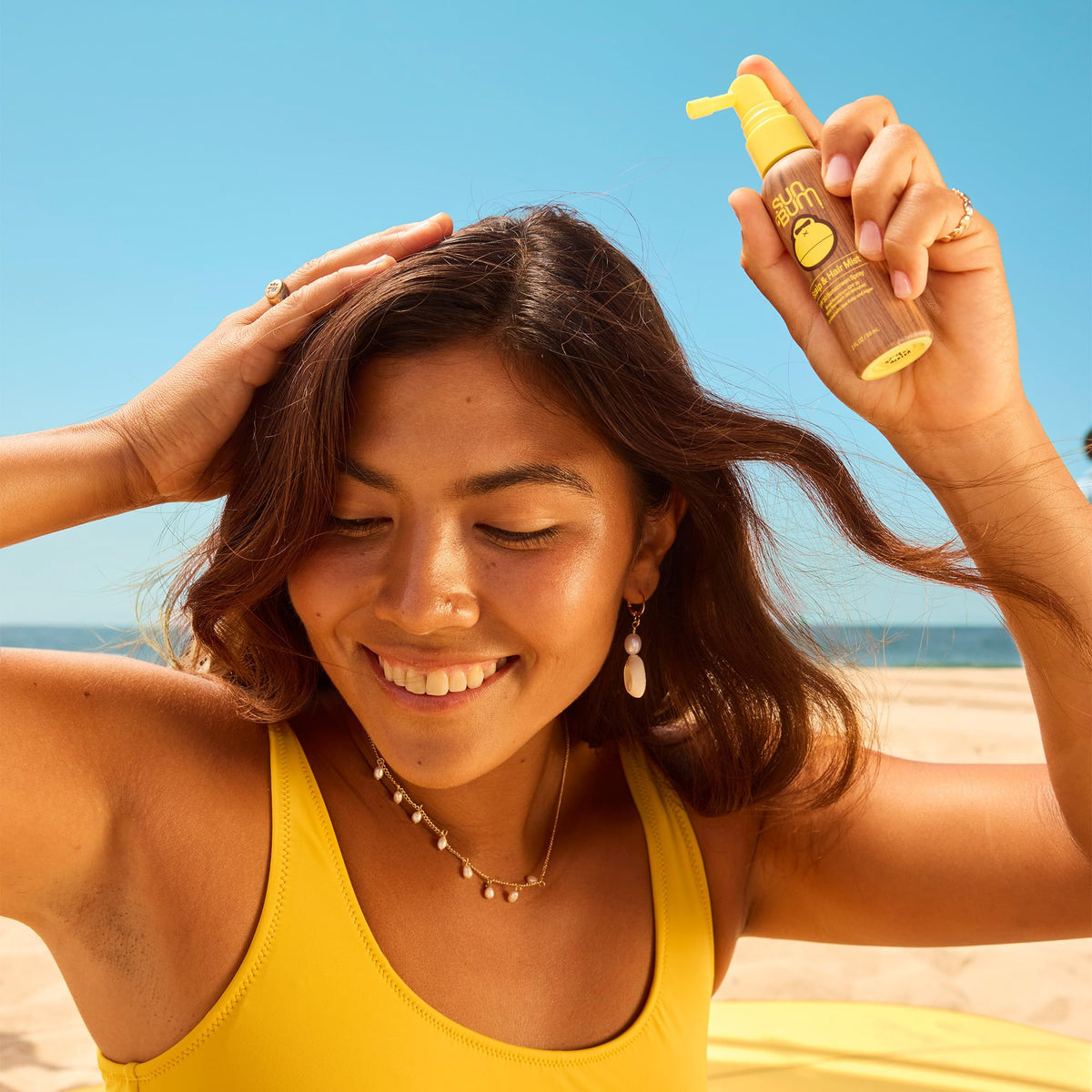 Sun Bum being applied to scalp demonstrating targeted sun protection