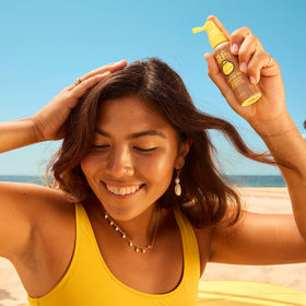 Sun Bum being applied to scalp demonstrating targeted sun protection