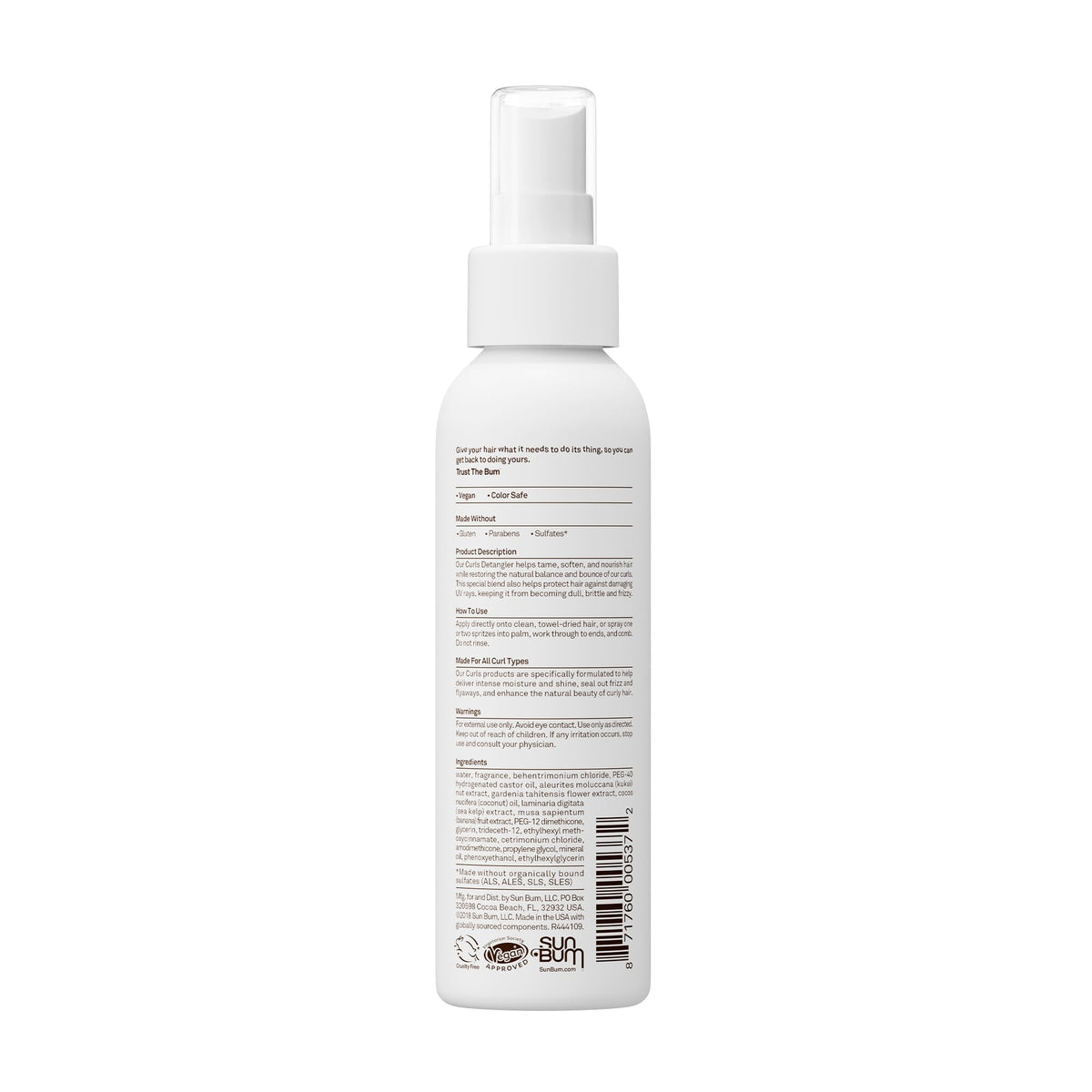 Model using Sun Bum detangler at the beach protecting curls and reducing frizz outdoors