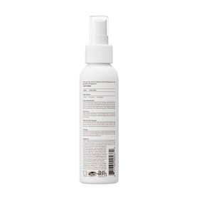 Model using Sun Bum detangler at the beach protecting curls and reducing frizz outdoors