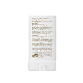 Sun Bum face stick on a beach towel showing reef-friendly outdoor use
