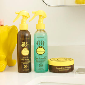 Sun Bum in-use spray action on damp hair, speeds blow-dry and smooths