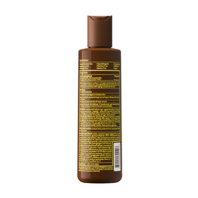Sun Bum bottle on sand at beach illustrating water-resistant protection