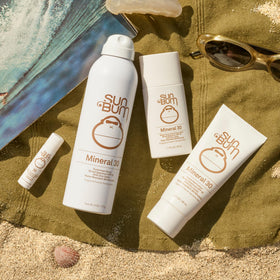 Sun Bum 3 oz tube beside sunglasses illustrating travel-size convenience