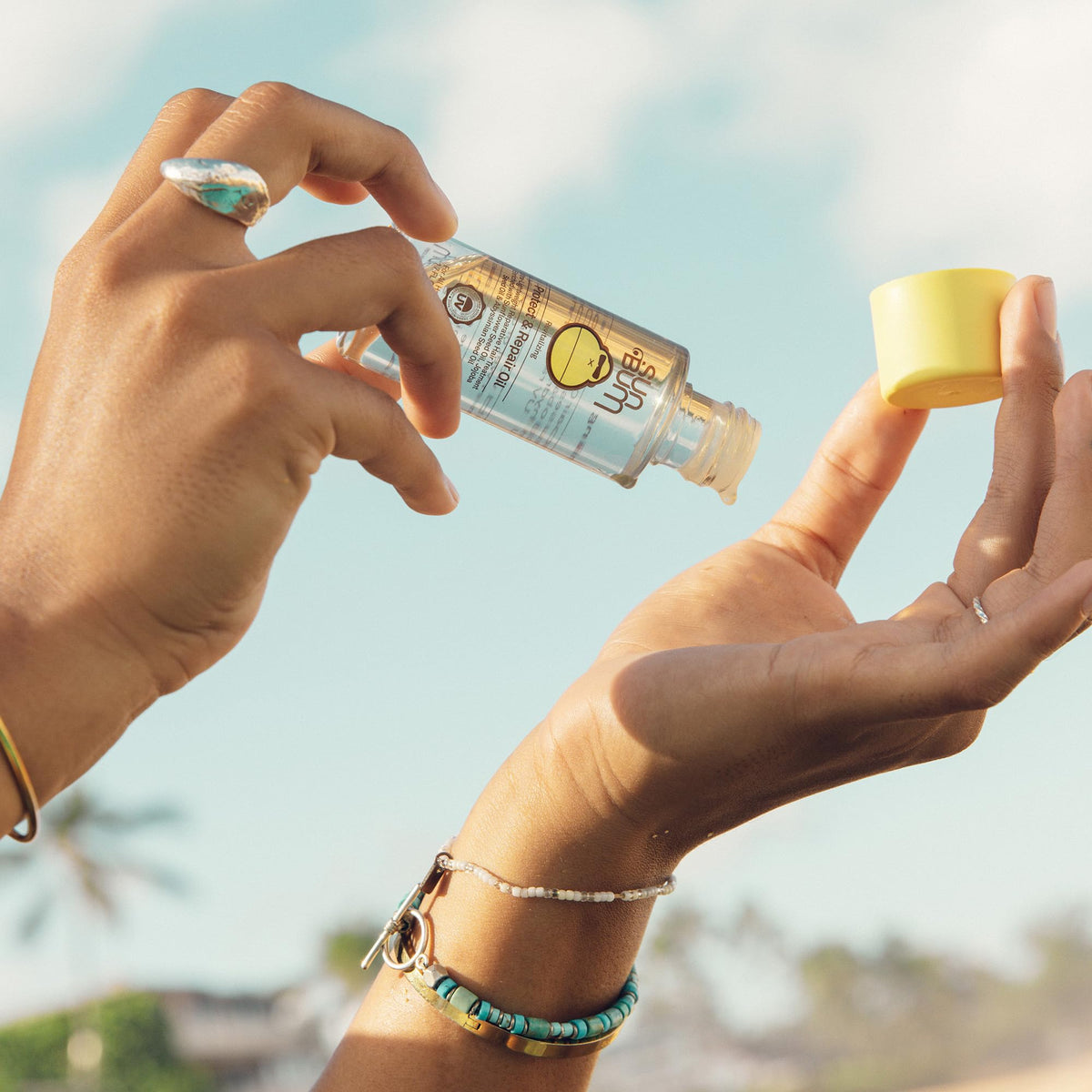 Sun Bum oil texture on hand demonstrating lightweight absorption and shine