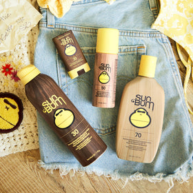 Sun Bum 3 oz roll-on beside a hand showing compact travel-friendly size