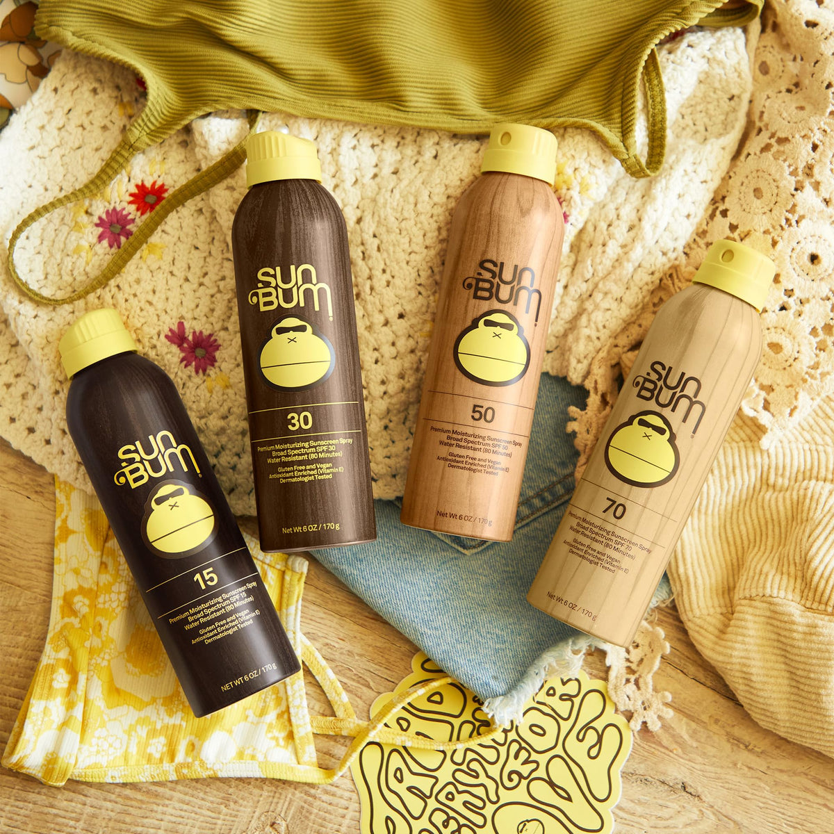 Sun Bum next to sunglasses and towel showing 6 oz travel-friendly bottle size