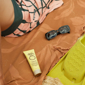 Application of Sun Bum SPF 70 on cheek demonstrating easy absorption and hydration