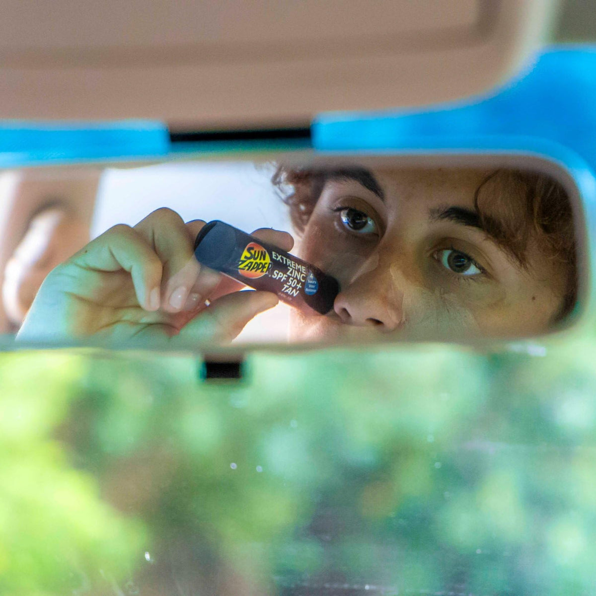 Applying Sun Zapper on nose demonstrating precise sun protection