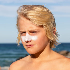 Sun Zapper used by surfer on cheek showing water-resistant protection