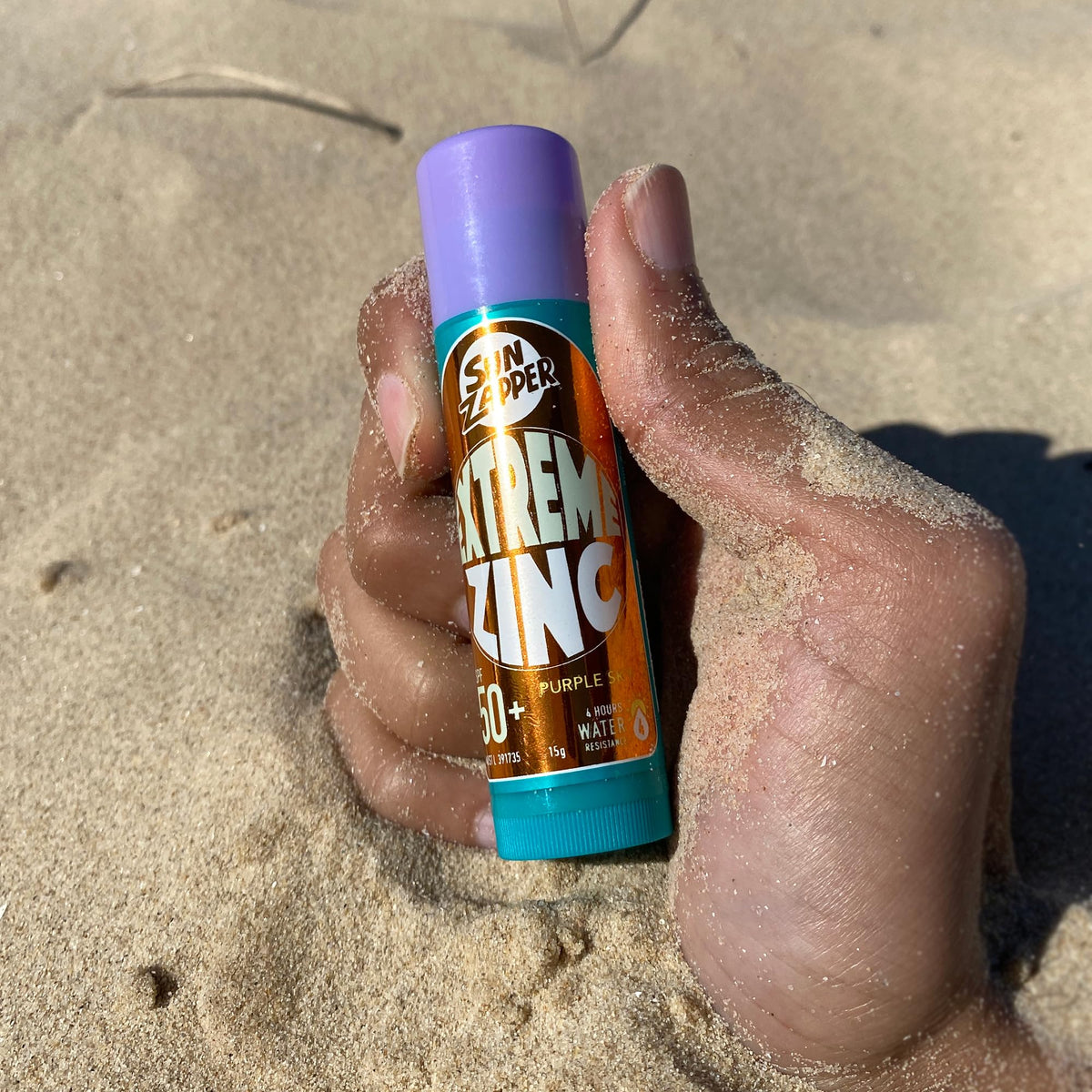 Sun Zapper on surfer at shoreline demonstrating visible protection and active use