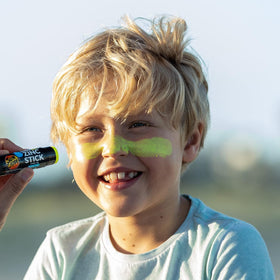 Sun Zapper being applied to a child outdoors for visible coverage