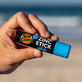 Sun Zapper next to a credit card showing compact 12g travel size portability