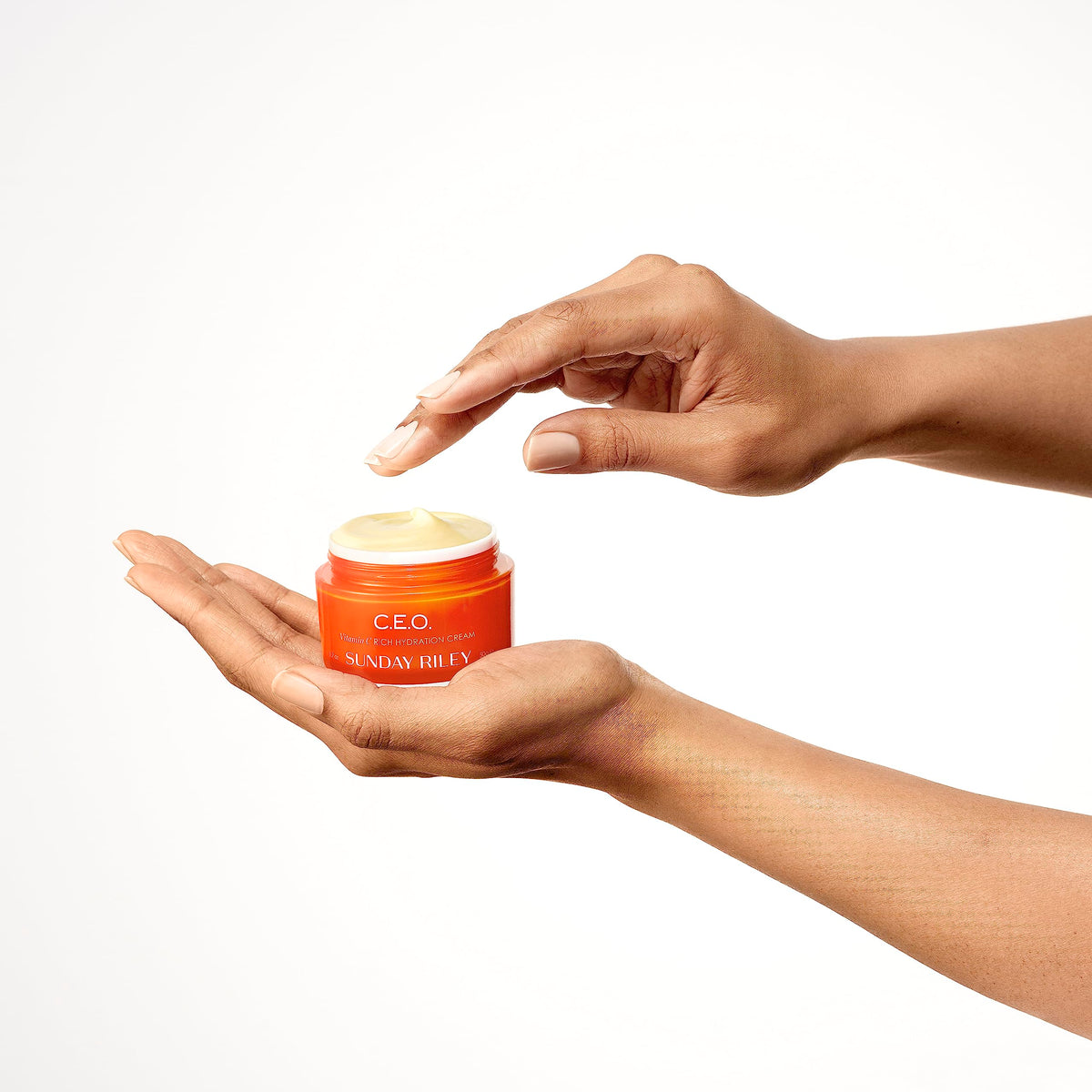 Sunday Riley jar next to coin showing product size and convenient travel-friendly benefit