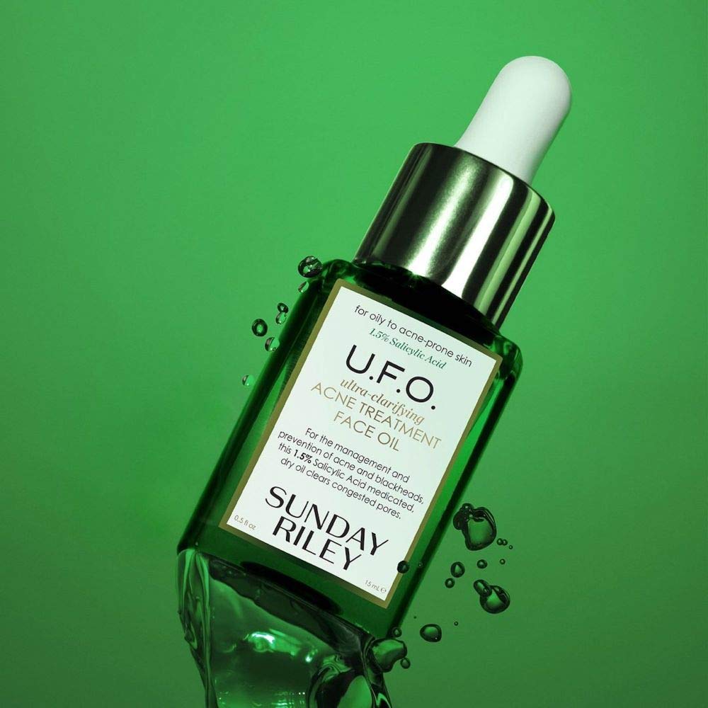 Sunday Riley U.F.O. bottle beside a coin showing 0.5oz scale for precise dosing benefit