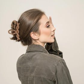 Sunolga lifestyle image of woman wearing an updo clip offering quick polished styling