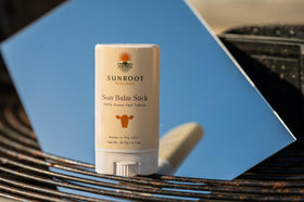 Sunroot Naturals sun stick in beach setting demonstrating outdoor use