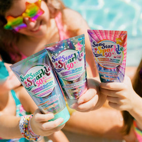 Sunshine & Glitter next to a credit card showing compact 3.4 oz size for packing
