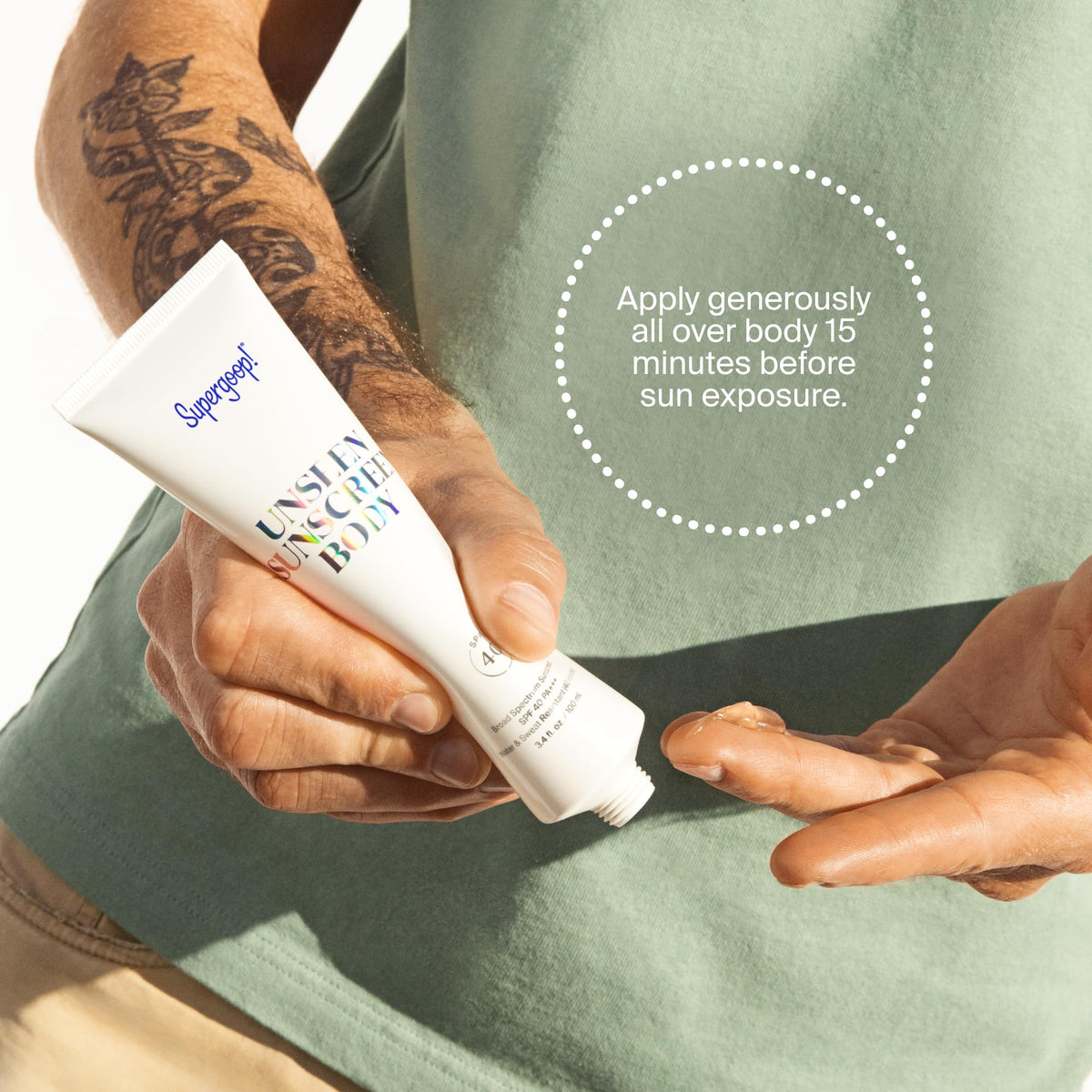 Supergoop! open tube beside hand to show product size and scale