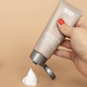 SURFACE applied to damp hair by hand showing even distribution and prep before styling