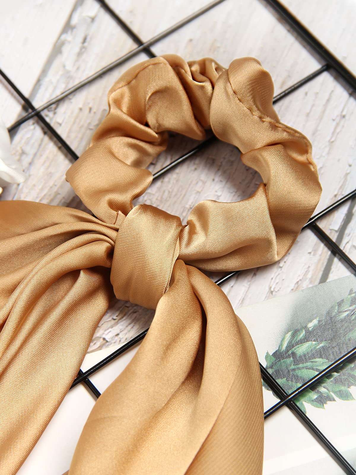 SUSULU bow detail showing tied ribbon ends for polished hair accents
