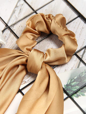 SUSULU bow detail showing tied ribbon ends for polished hair accents