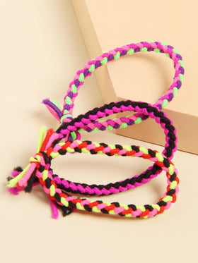 SUSULU hair tie next to a hand to show size and easy carrying benefit