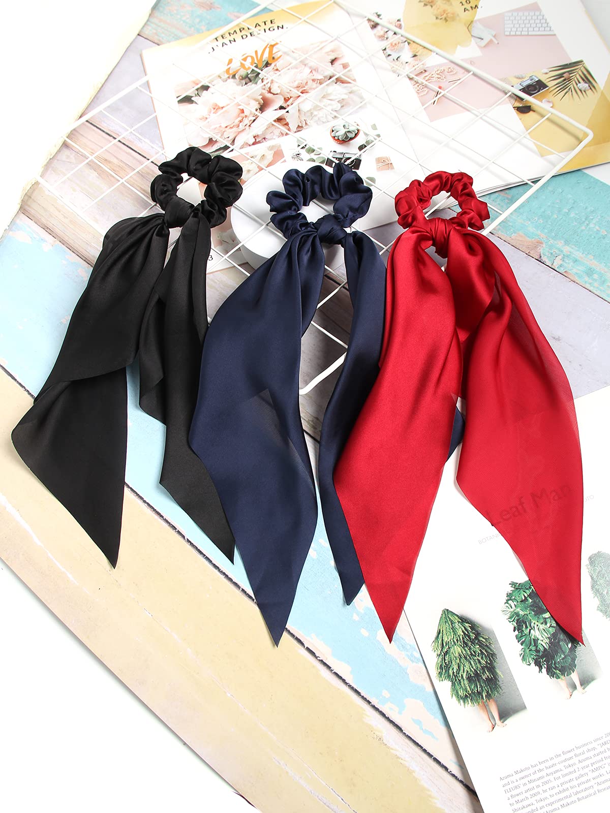 SUSULU scrunchie holding a ponytail securely while adding satin bow decoration