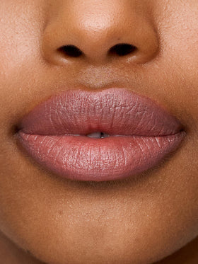 Sweed Le Lipstick swatch on arm showing buildable nude pink color payoff