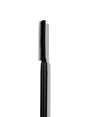 Sweed mascara next to coin size comparison illustrating compact travel-friendly tube