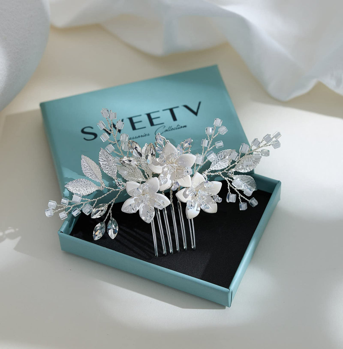 SWEETV comb in packaging staged in a bridal dressing setting for presentation