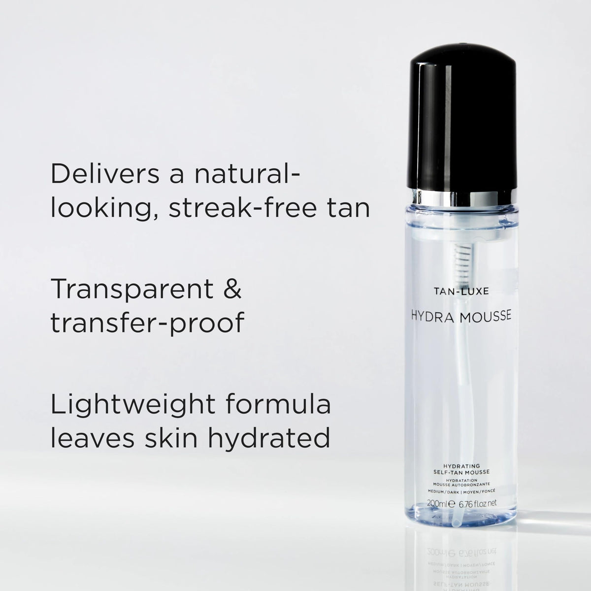 TAN-LUXE applying mousse with mitt for streak-free even coverage