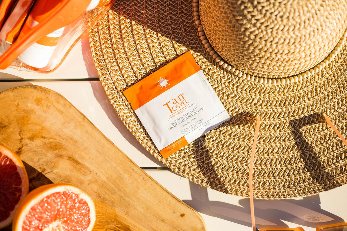 Tan Towel towelette being smoothed on arm close-up for even natural-looking tan benefit