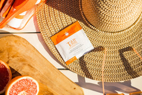 Tan Towel towelette being smoothed on arm close-up for even natural-looking tan benefit