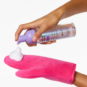 Tanologist mousse on palm showing clear-to-foam transformation for precise application