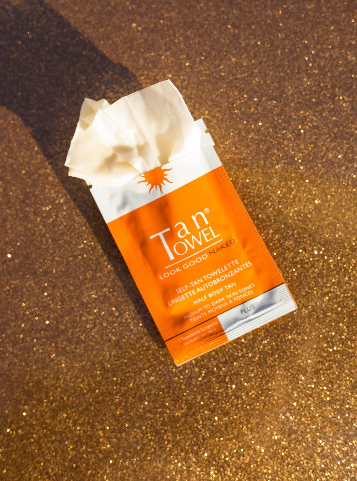 TanTowel being applied to leg demonstrating streak-free, fast-drying benefit
