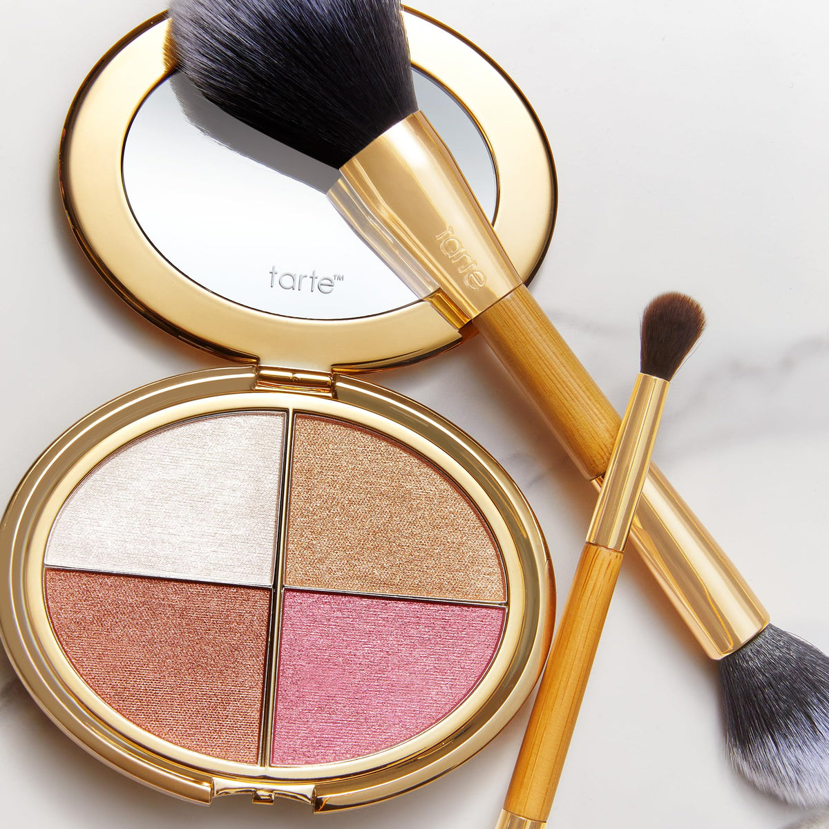 tarte palette next to coin showing compact travel-friendly scale
