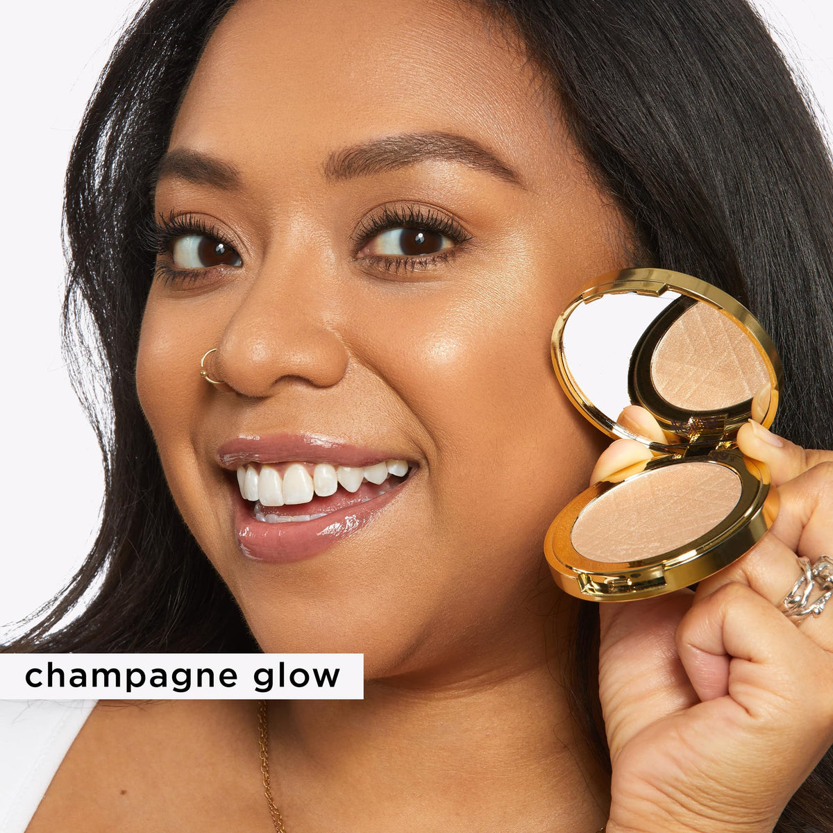 tarte compact beside coin for size comparison, shows travel-friendly portability