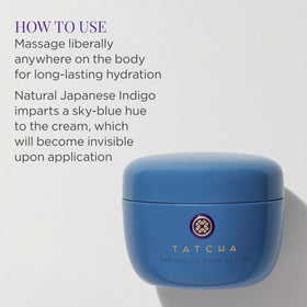 TATCHA indigo body butter next to hand to show jar size and travel-friendly quantity