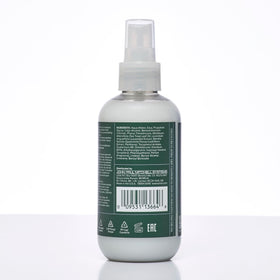 Tea Tree bottle on bathroom shelf with plants showing calming spa-like benefit