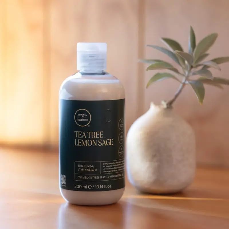 Tea Tree 33.8 fl oz bottle beside common household item for scale