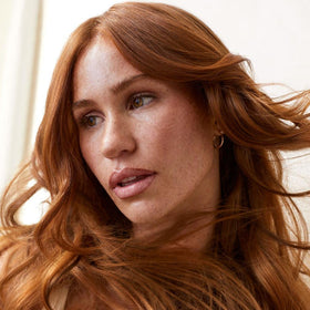Tea Tree spray in motion on hair, demonstrating instant lift and styling grip