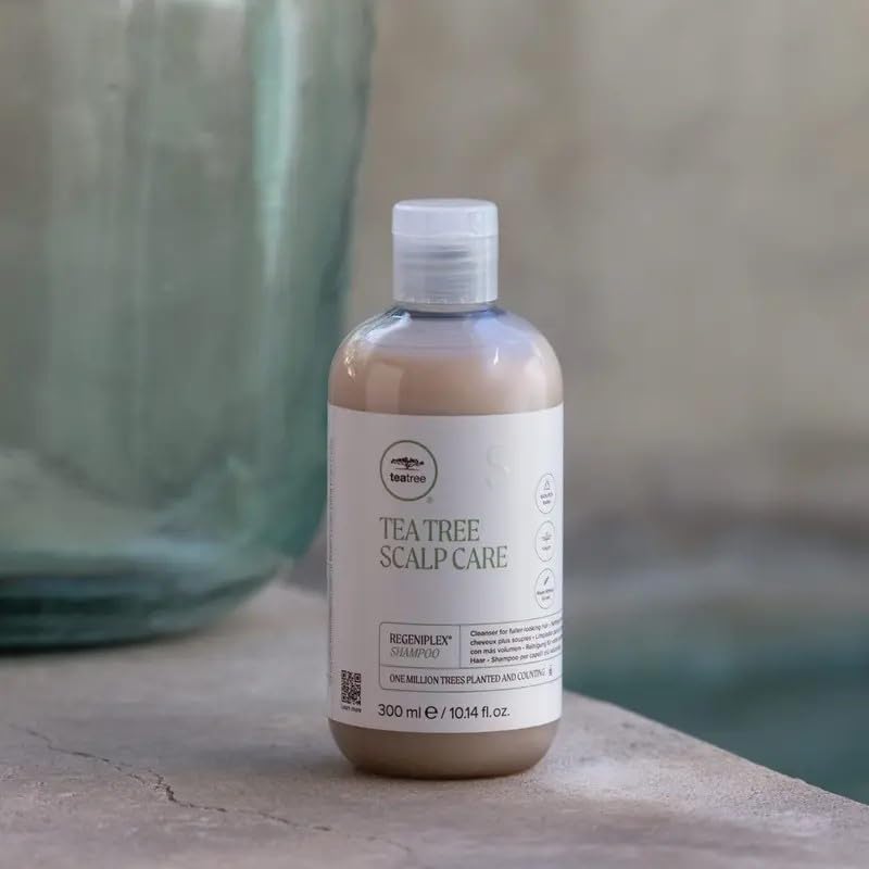 Tea Tree bottle held in hand to show 10.14 fl. oz scale and travel-friendly convenience